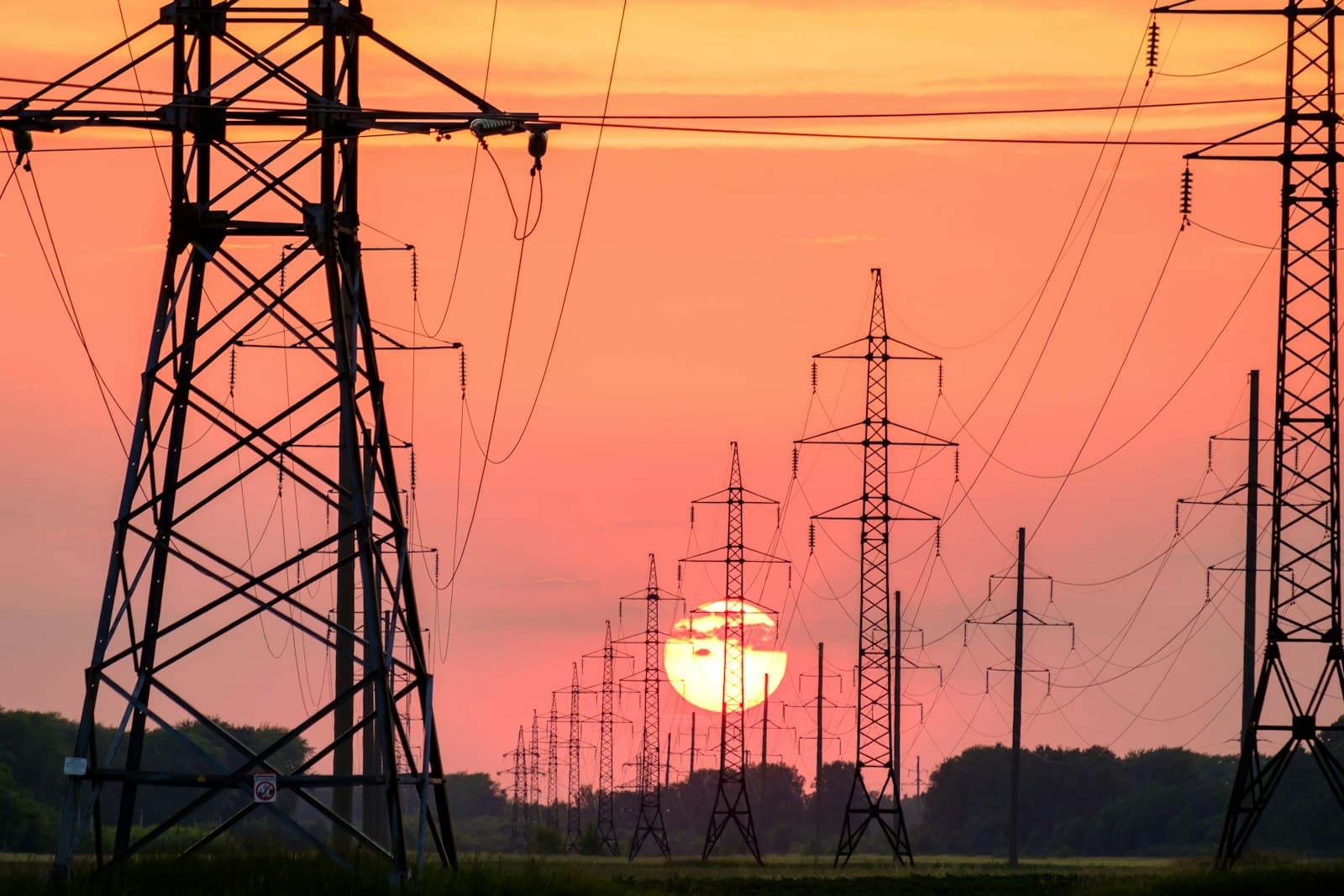 Energy transmission grid at sunset